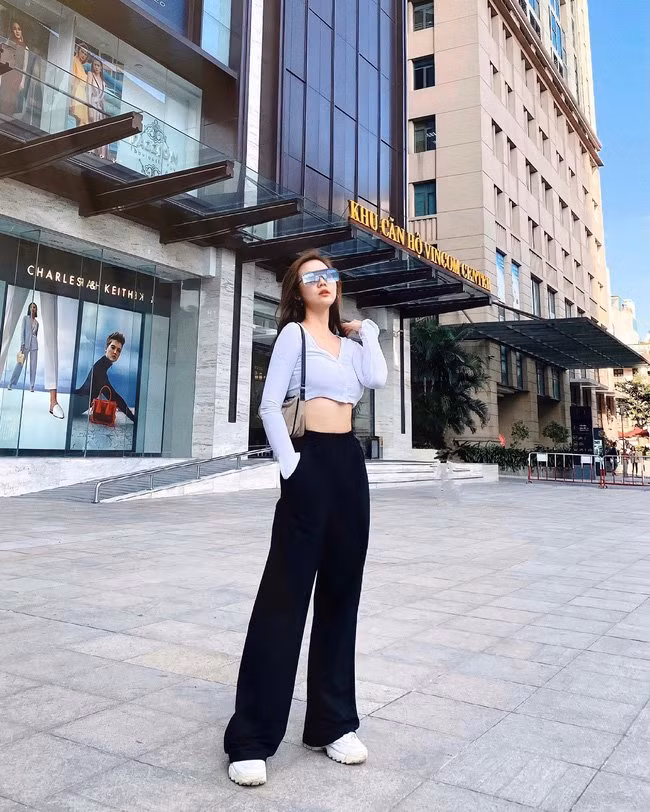 Chị em cứ kết hợp áo crop top trắng với quần ống rộng mang tông màu đen, vẻ ngoài đã rất thời thượng, đầy phá cách.