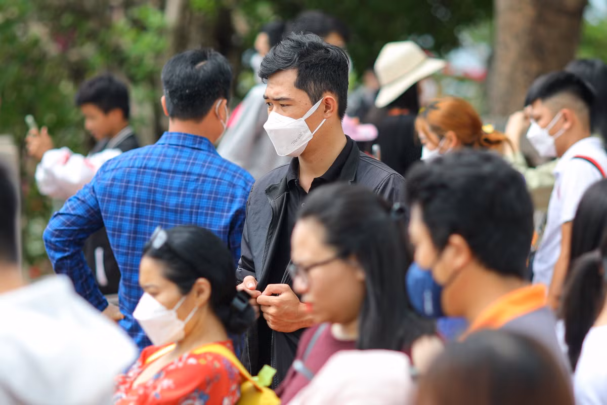 Nhiều du khách tỏ ra khó chịu khi đứng dưới trời nắng, đợi gần 30 phút mới đến lượt chụp ảnh.