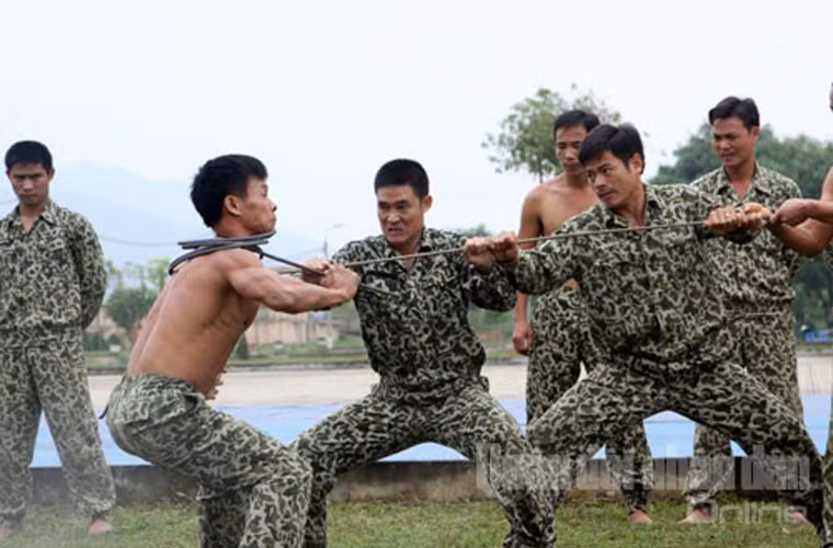 Chiến sĩ đặc công Việt Nam đang vận nội công quấn thanh sắt như quấn khăn quanh cổ trong buổi trình diễn võ thuật vào sáng 12/11 tại Trường Sĩ quan Đặc công, báo cao kết quả huấn luyện cho các lãnh đạo Bộ Quốc phòng, Binh chủng Đặc công và đặc biệt là các sĩ quan lực lượng tác chiến đặc biệt Quân đội Australia.