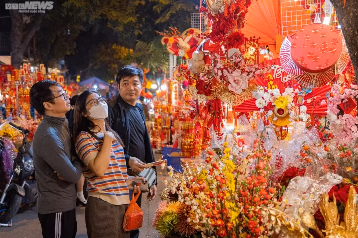 Gia đình chị Kim Anh (Cầu Giấy, Hà Nội) cho biết: "Hàng năm, gia đình tôi thường về quê đón Tết nhưng chúng tôi vẫn đến đây để mua đồ trang trí cho ngôi nhà ở Hà Nội, để luôn có không khí Tết. Tôi thấy năm nay nhiều mặt hàng đa dạng, phong phú hơn nhưng giá cũng có phần nhỉnh hơn so với năm trước".