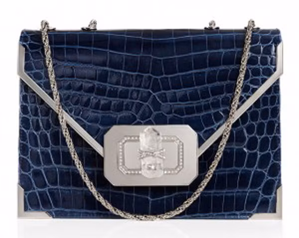9. Chiếc túi Valentino Crocodile Evening của thương hiệu Marchesa này có giá 8.595 USD. Chiếc túi sang trọng này được làm bằng chất liệu da cá sấu, phần dây đeo làm bằng bạc. Điểm đắt giá của chiếc túi chính là phần khóa xoay được thiết kế độc đáo với một viên pha lê to và xung quanh khóa cũng được gắn một đường viền pha lê nhỏ tinh tế.