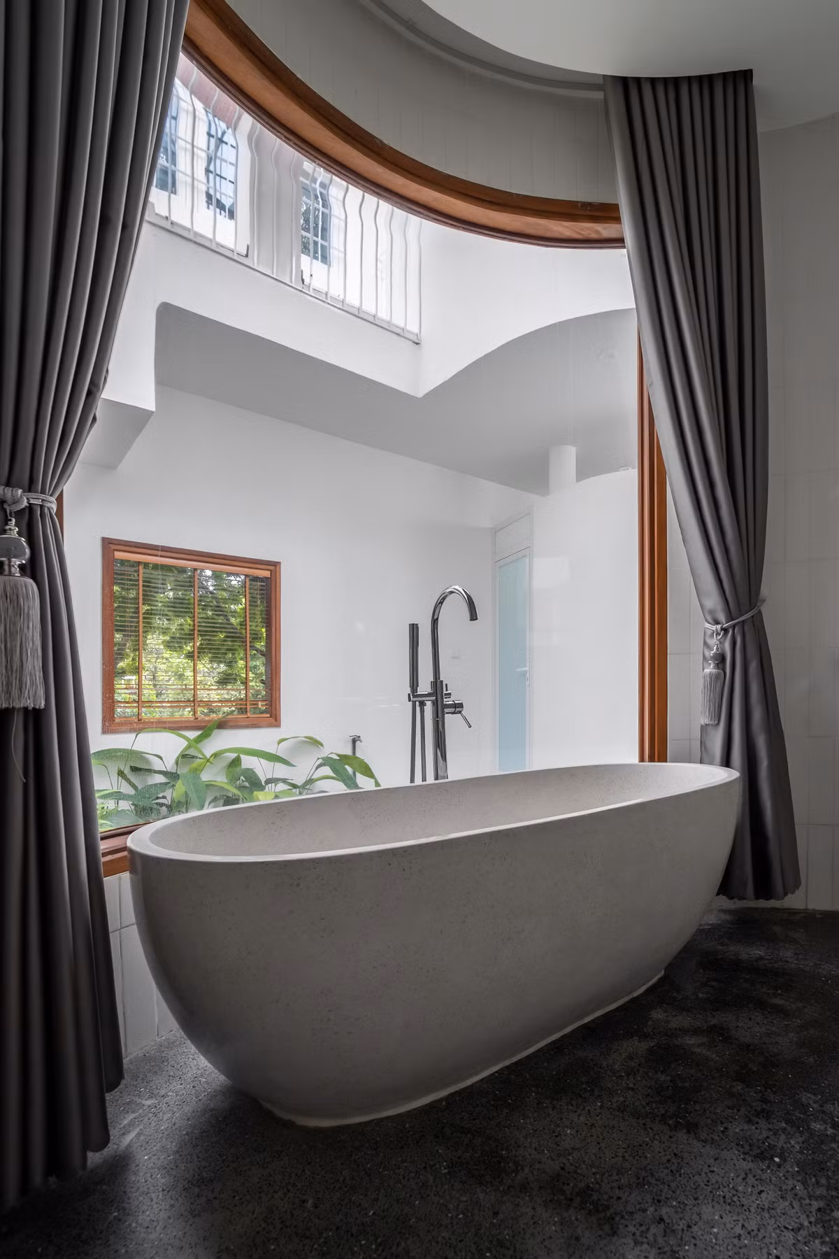 Phòng tắm nhìn ra vườn với cửa kính lớn.