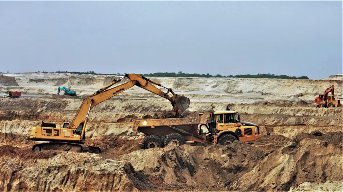 Giai đoạn 2008-2011, chủ đầu tư đã cho bóc đất tầng phủ được khoảng 12,7 triệu m3, độ sâu -34 m so với mực nước biển, thu hồi khoảng 3.000 tấn quặng. Tuy nhiên, đến tháng 11/2011, Chính phủ phải cho tạm dừng dự án để thẩm định lại thiết kế kỹ thuật và tái cơ cấu cổ đông do vướng mắc về huy động và góp vốn, dẫn đến hệ lụy như: Chậm tiến độ giải phóng mặt bằng, thiếu tiền thanh toán cho nhà thầu tư vấn lập thiết kế kỹ thuật và xây dựng khu tái định cư.