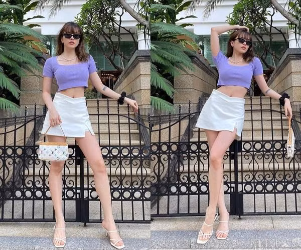 Trong bộ đồ kết hợp giữa áo crop-top màu tím đúng xu hướng và chân váy chữ A, ca sĩ Thiều Bảo Trâm lựa chọn phụ kiện giày và túi xách tông trắng nền nã, nhấn nhá họa tiết nhiều màu sắc tạo nên tổng thể trẻ trung.