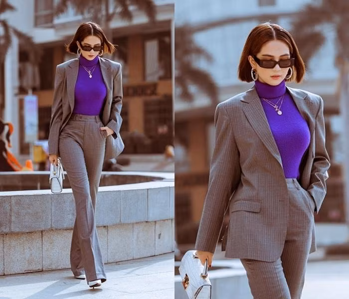 Áo len cổ lọ sơ vin cùng quần ống suông phủ kín giày cao gót là lối kết hợp khôn ngoan khiến người đẹp gia tăng đáng kể chiều cao. Chiếc áo len bó sát tuy "kín cổng cao tường" nhưng tôn vòng 1 nóng bỏng cùng vòng 2 thon gọn. Ba tông màu tím, trắng, xám mix không nhạt nhoà.