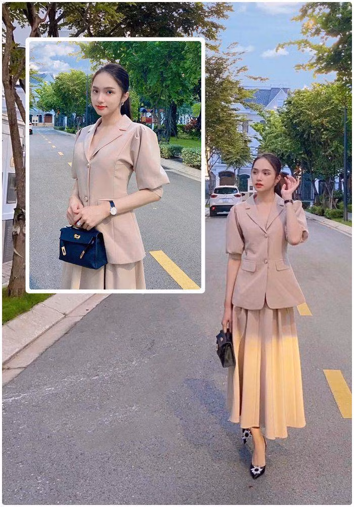 Hương Giang "lên đồ" đi làm chuẩn style công sở khi mix áo vest tay cộc cùng chân váy xếp ly, không thể thiếu túi xách hàng hiệu và giày cao gót.