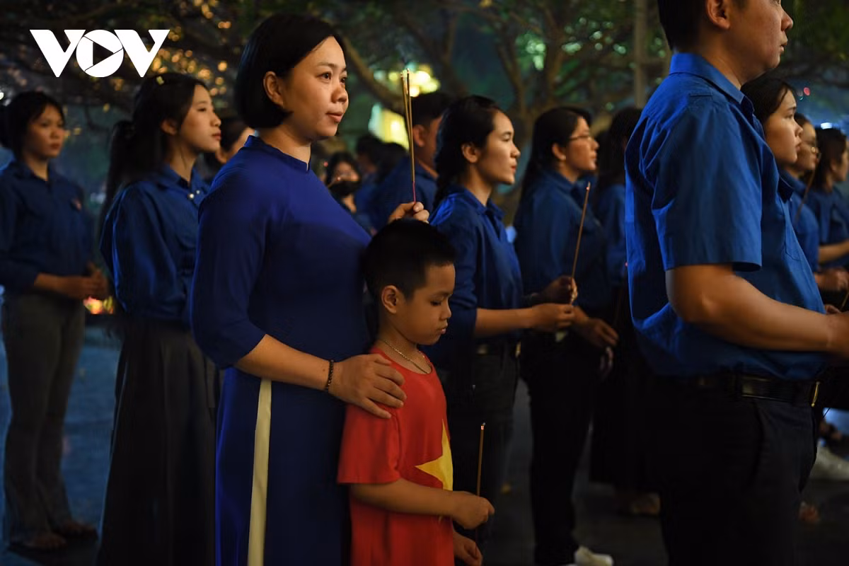 Một em nhỏ đi theo mẹ tham dự buổi lễ.