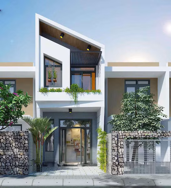 Bất cứ ai cũng sẽ bị thu hút bởi mẫu thiết kế nhà ống 2 tầng đơn giản nhưng không kém phần đẹp mắt này. Mái xéo ấn tượng, cây xanh được trồng đan xen ở nhiều vị trí, tạo nên vẻ đẹp riêng, gần gũi thiên nhiên