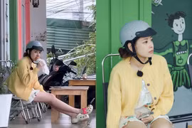 Chi Pu mặc đồ ngủ, đội mũ bảo hiểm gặm bánh mì lề đường