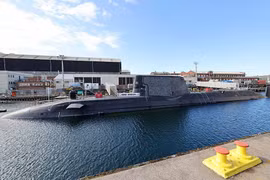 Tàu ngầm hạt nhân tấn công HMS Anson (S123) của Hải quân Hoàng gia Anh neo tại cảng. Đây là tàu ngầm lớp Astute, có khả năng mang tên lửa hành trình Tomahawk và thực hiện các nhiệm vụ răn đe, tấn công tầm xa.