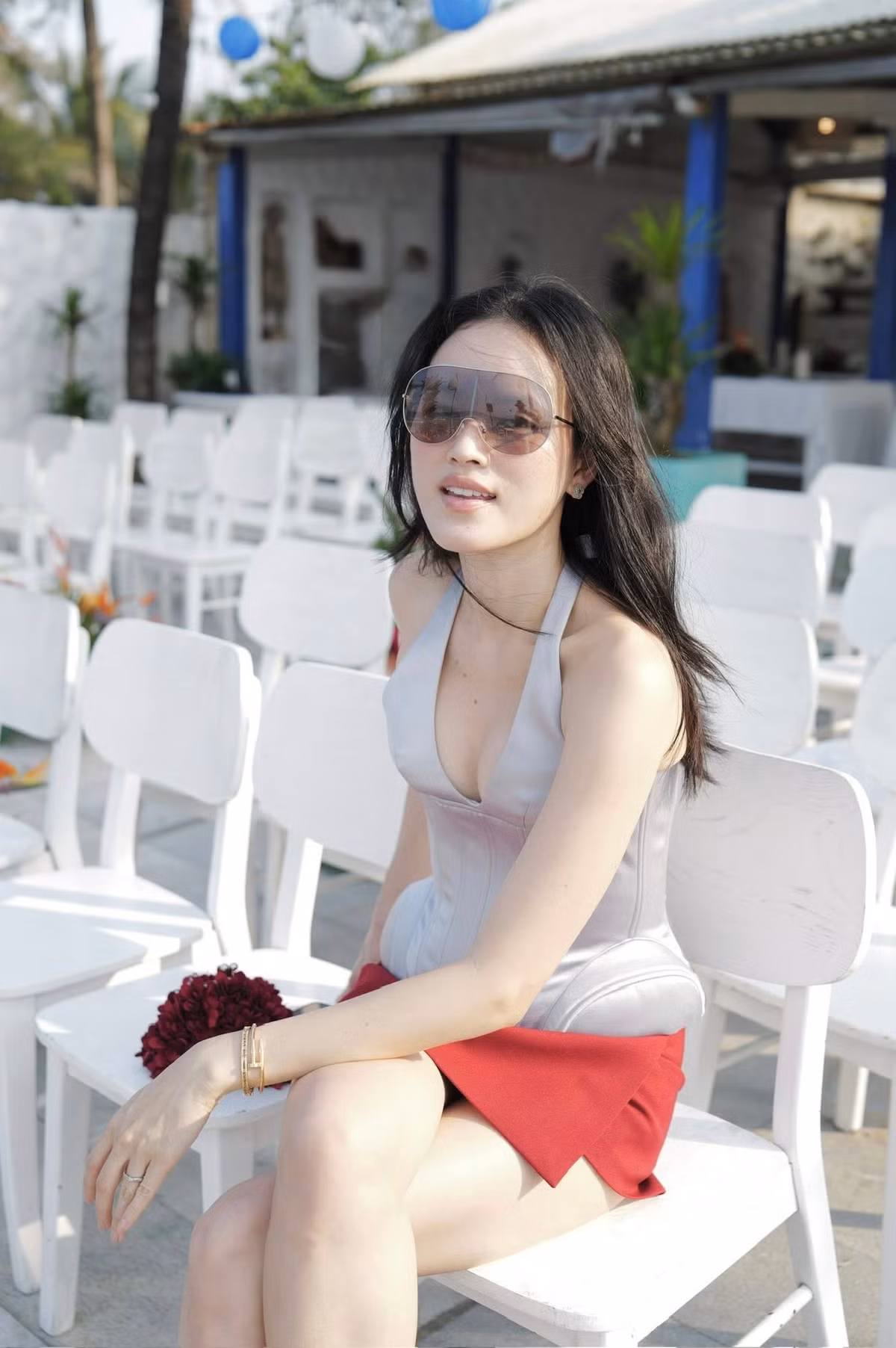 Nữ người mẫu lựa chọn chiếc váy ngắn màu đỏ nổi bật, kết hợp cùng áo cổ yếm khoét ngực sâu khéo léo tôn lên đường cong cơ thể gợi cảm, đầy cuốn hút.