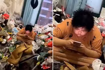 Sốc: Cô gái sống giữa đống rác chất cao tới cửa sổ căn hộ
