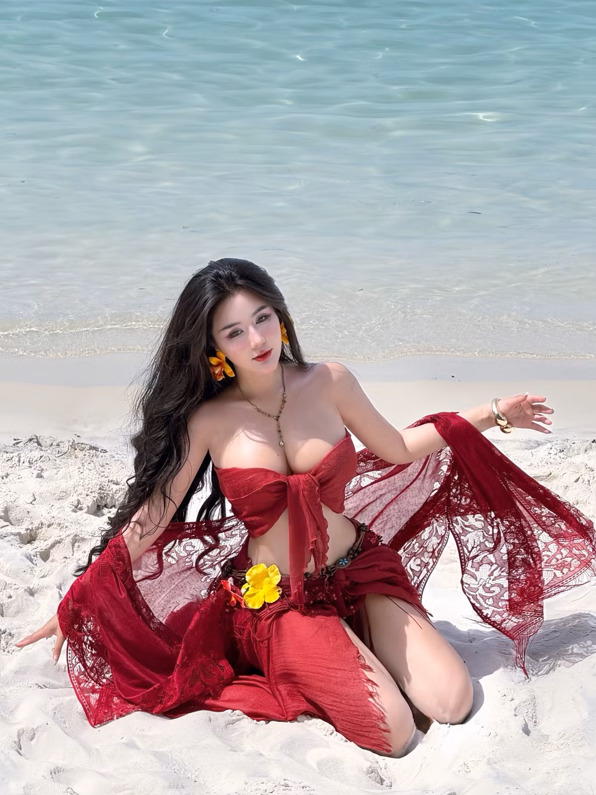 Nàng hot girl Sài thành lựa chọn một chiếc váy maxi màu đỏ rực rỡ, thiết kế ôm sát cơ thể, đặc biệt là những đường cắt xẻ táo bạo ở hai bên eo và phần tà váy.
