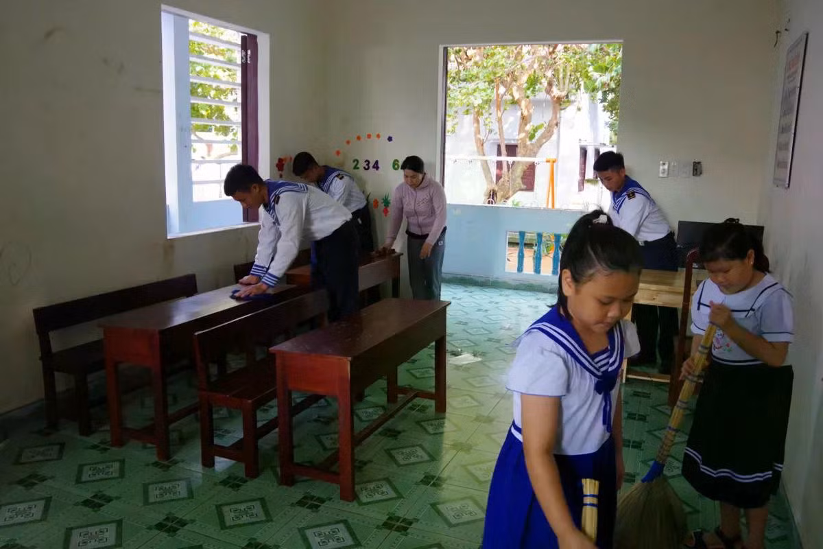 Cán bộ chiến sĩ, phụ huynh và học sinh vệ sinh lớp học trước ngày khai giảng.