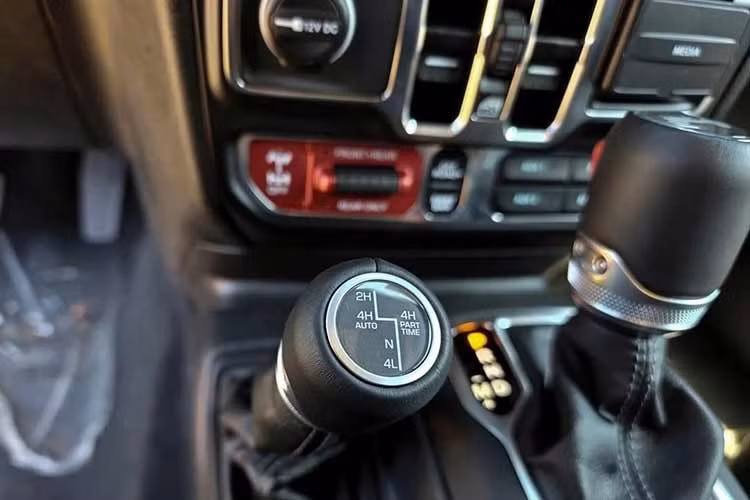 Khác với nhiều mẫu xe đời mới thường tối giản nút bấm, táp-lô của Jeep Wrangler vẫn duy trì nhiều phím vật lý cho hệ thống điều hòa và các chức năng vận hành. Hàng ghế trước cũng có tính năng sưởi. Các nút nâng, hạ kính được đặt ở bảng táp-lô thay vì trên cửa. Cách bố trí này giúp hạn chế hệ thống dây điện đi vào cánh cửa, phù hợp với thiết kế cửa tháo rời.