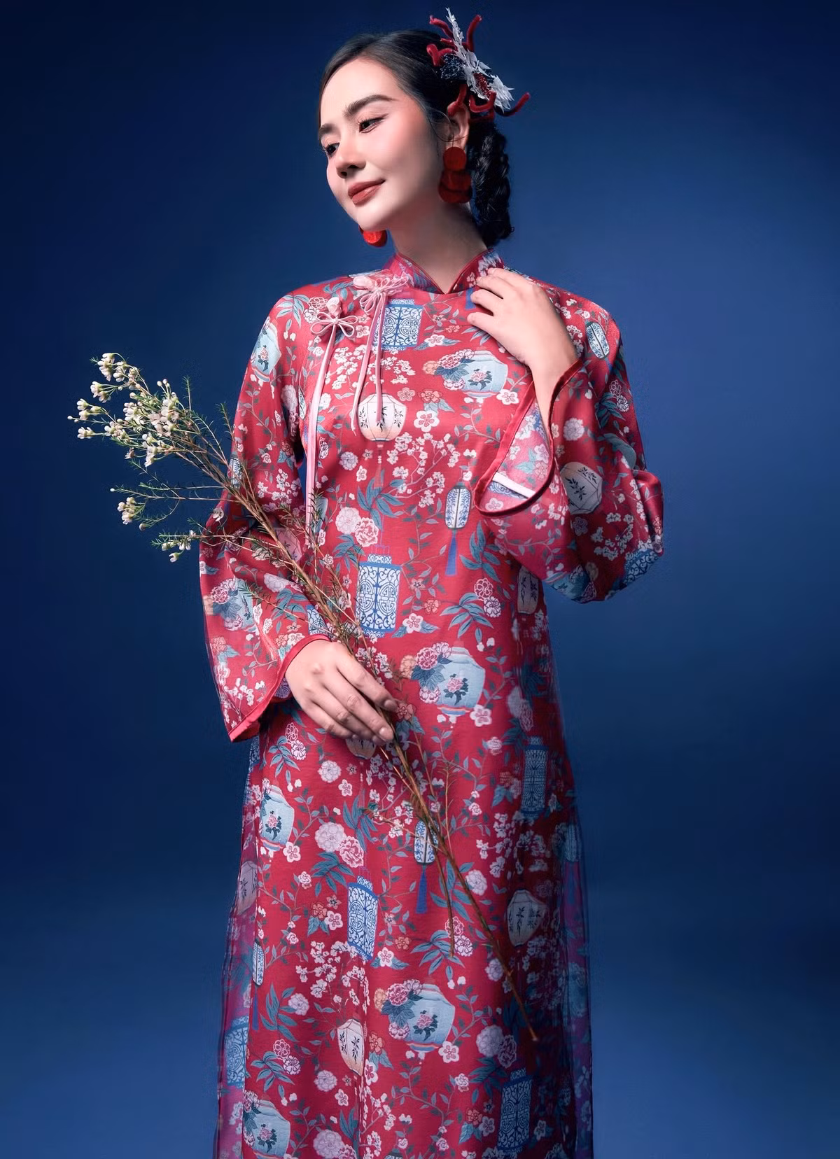 Phom dáng áo dài ôm vừa vặn giúp nữ diễn viên tôn lên vóc dáng thanh mảnh, trong khi chất liệu lụa, gấm rủ nhẹ mang lại cảm giác uyển chuyển, tinh tế.