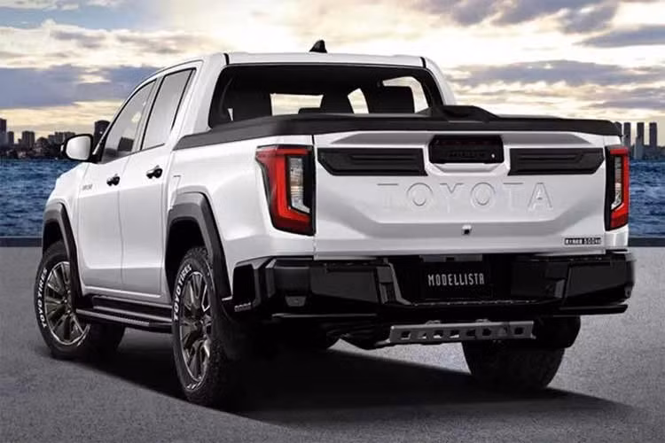 Gói nâng cấp Modellista cho Toyota Hilux 2026 mới được bổ sung nhiều chi tiết màu đen ở nắp ca-pô, viền đèn pha và cửa thùng hàng phía sau. Cản trước và cản sau cũng được thiết kế lại với các chi tiết trang trí tích hợp đèn LED.