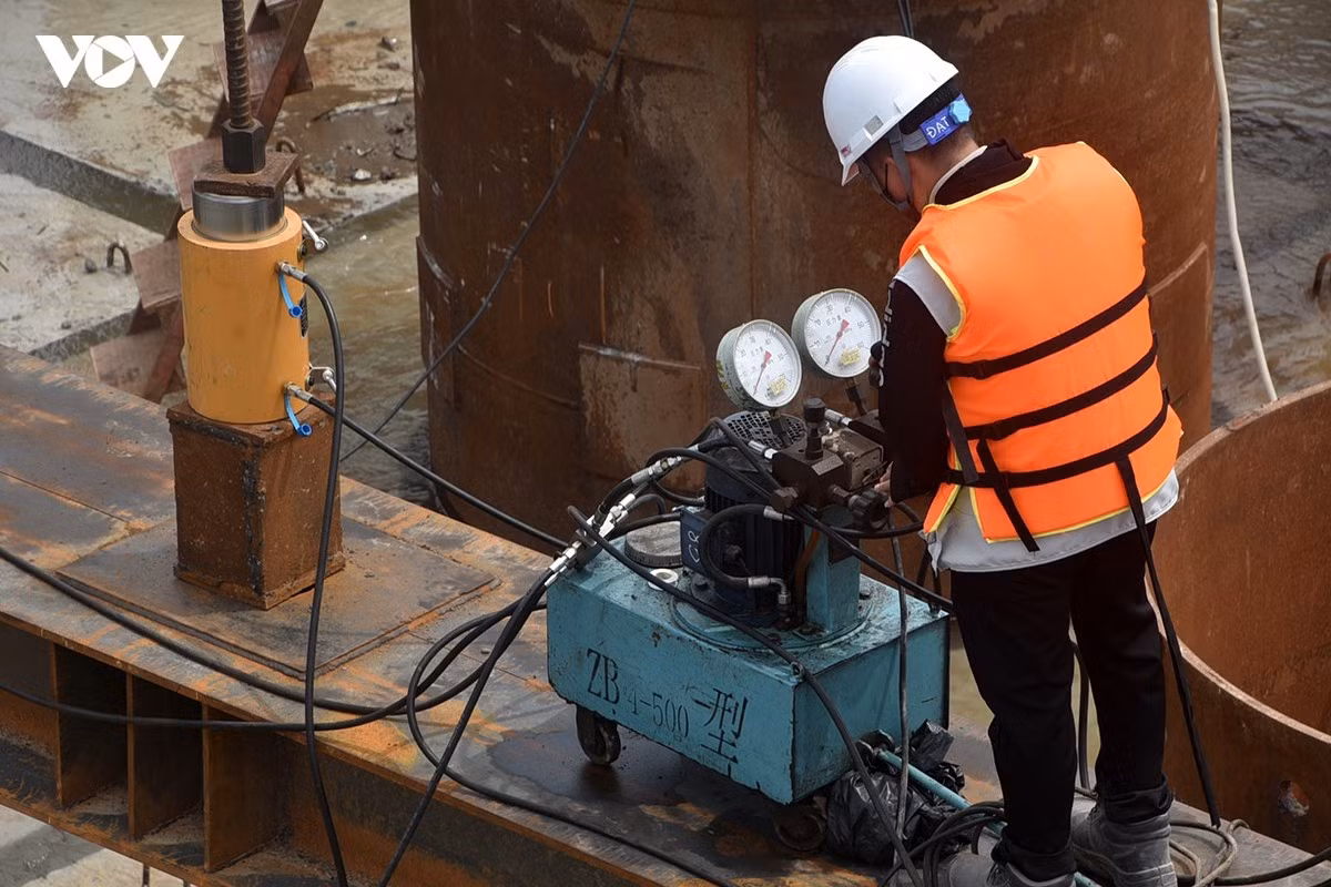 Sau đó đùng kích thủy lực hạ thùng chụp.