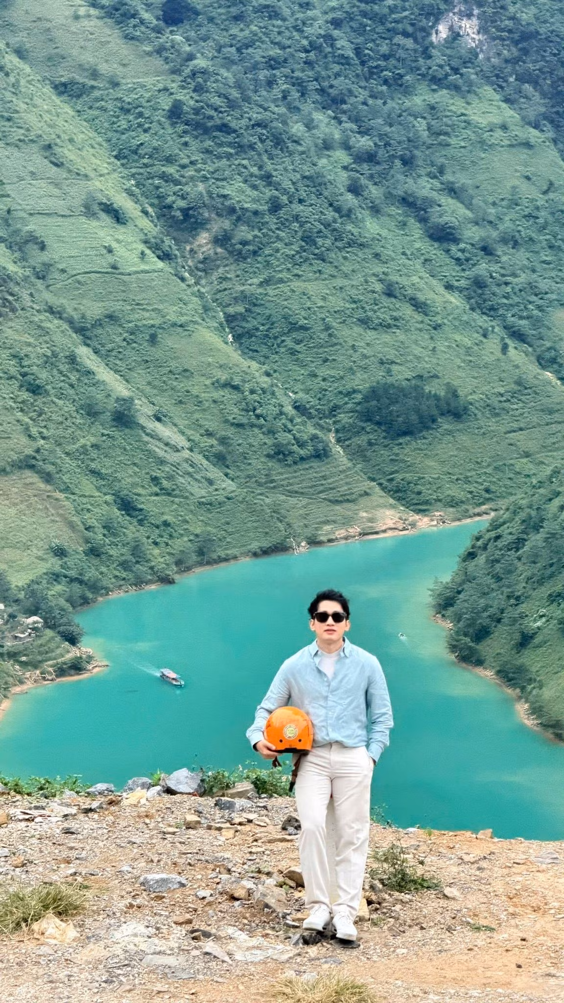 Sông Nho Quế bắt nguồn từ vùng núi Vân Nam (Trung Quốc) và chảy gần 50 km trên lãnh thổ Việt Nam, uốn lượn qua những vách núi dựng đứng, tạo nên cảnh quan ngoạn mục. Nhìn từ đèo Mã Pì Lèng, dòng sông xanh thẳm nổi bật giữa sắc xám của núi đá, vàng của nắng và mây trắng trôi nhẹ, mang đến khung cảnh hài hòa và đậm chất thơ, chỉ cần giơ máy ảnh là có thể lưu giữ trọn vẻ đẹp thiên nhiên. Ảnh Hà Giang Tour