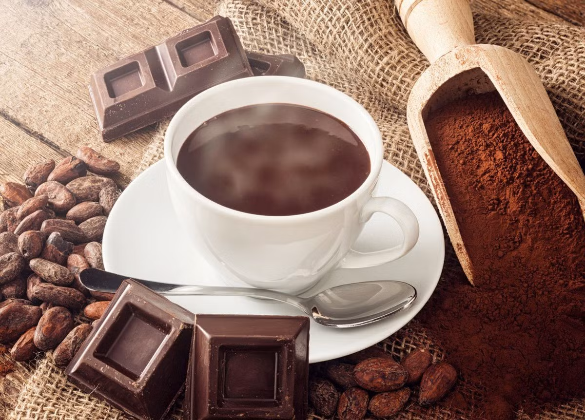 Để tốt cho sức khỏe, nên dùng bột ca cao nguyên chất pha với sữa tách béo hoặc nước ấm, chỉ thêm một ít mật ong hoặc đường ăn kiêng. Một chút bột quế rắc lên bề mặt không chỉ giúp hương vị thơm ngon mà còn tăng hiệu quả giữ ấm. Ảnh minh hoạ