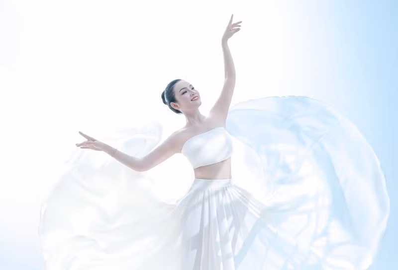 Trong bộ ảnh mới, Tân Nhàn diện áo crop top kết hợp với chân váy tông màu trắng. Nữ ca sĩ chọn kiểu tóc búi cao. Ảnh: FB Tân Nhàn.