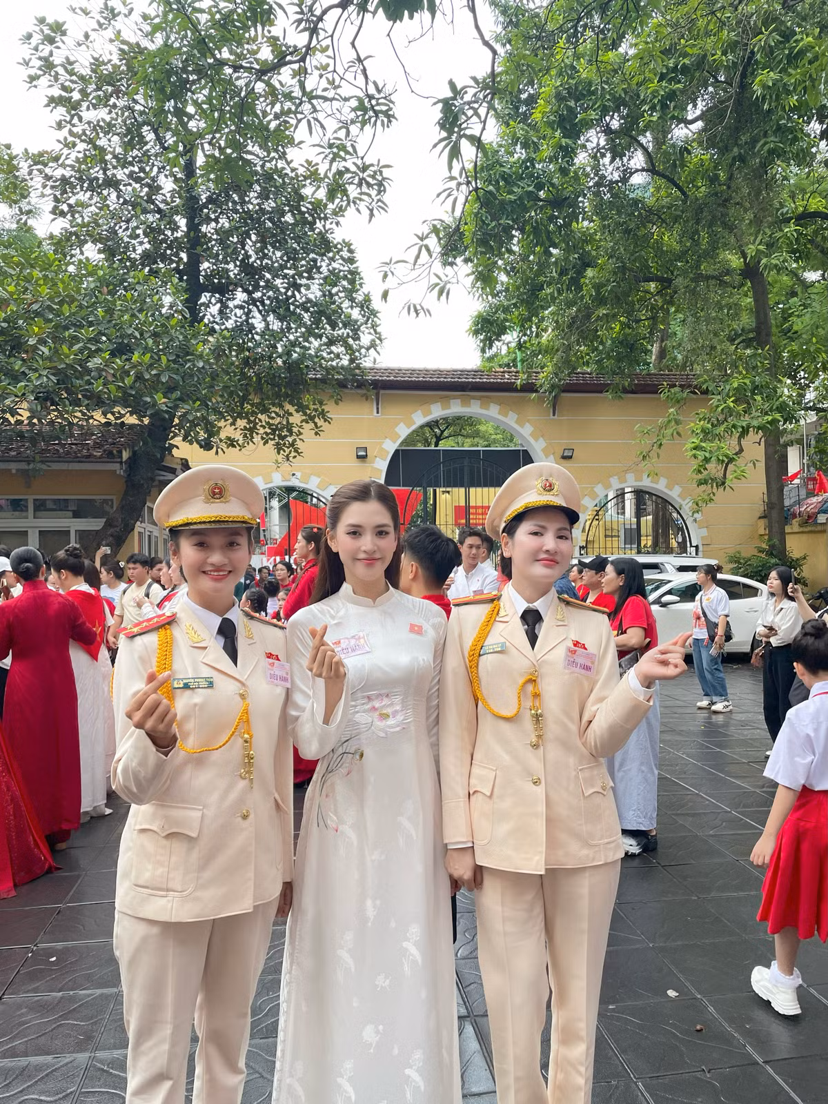 Hoa hậu Tiểu Vy diện áo dài trắng với điểm nhấn trên ngực trái là chiếc huy hiệu cài áo hình lá cờ Việt Nam. Ảnh: Sen Vàng.