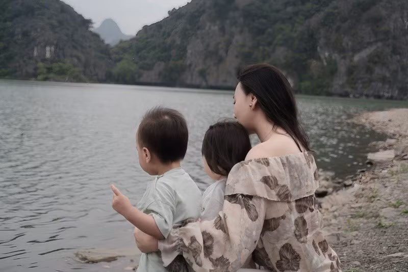 Trong một khung hình, Phương Oanh ôm hai con từ phía sau, để Jimmy và Jenny ngắm cảnh thiên nhiên. Ảnh: FB Phương Oanh.