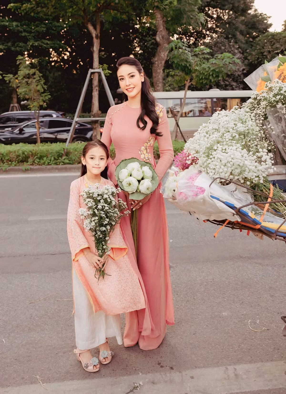 Hà Kiều Anh và con gái Viann diện áo dài hồng pastel nữ tính, chụp hình cùng hoa mùa thu. Ảnh: FB Ha Kieu Anh