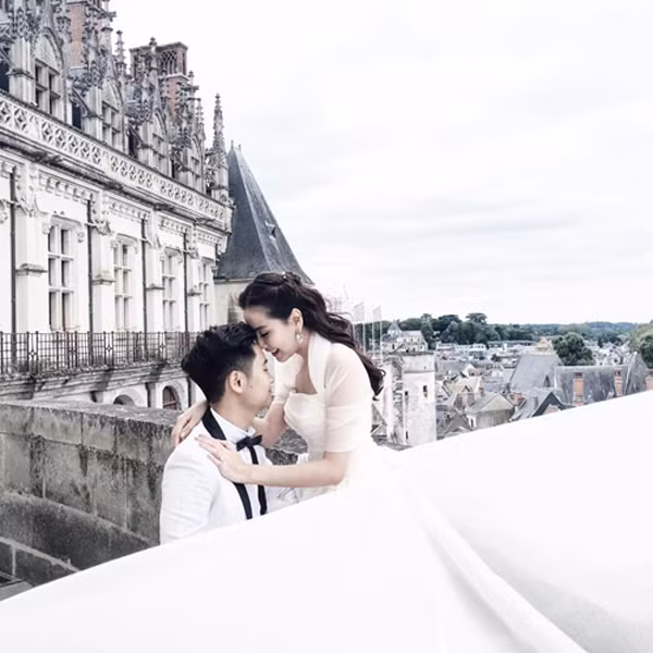 MC Mai Ngọc VTV diện váy cưới trắng, tình tứ nép sát mặt vào chồng trong khung cảnh nguy nga của những lâu đài Pháp hùng vĩ.