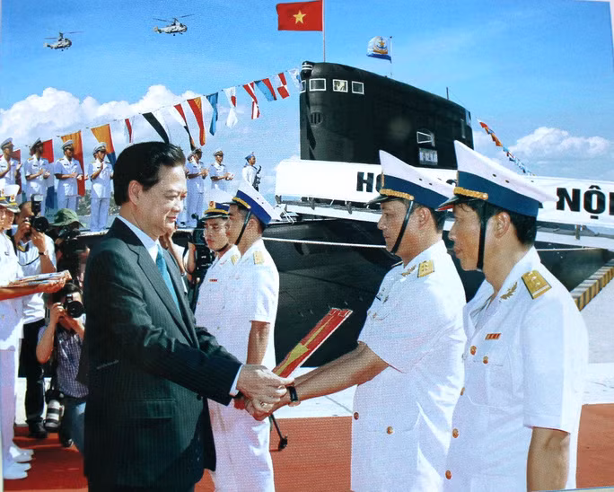Thủ tướng Nguyễn Tấn Dũng trao cờ cho thủy thủ đoàn của tàu kilo 636 HQ 182. Nguồn ảnh: NLĐ.