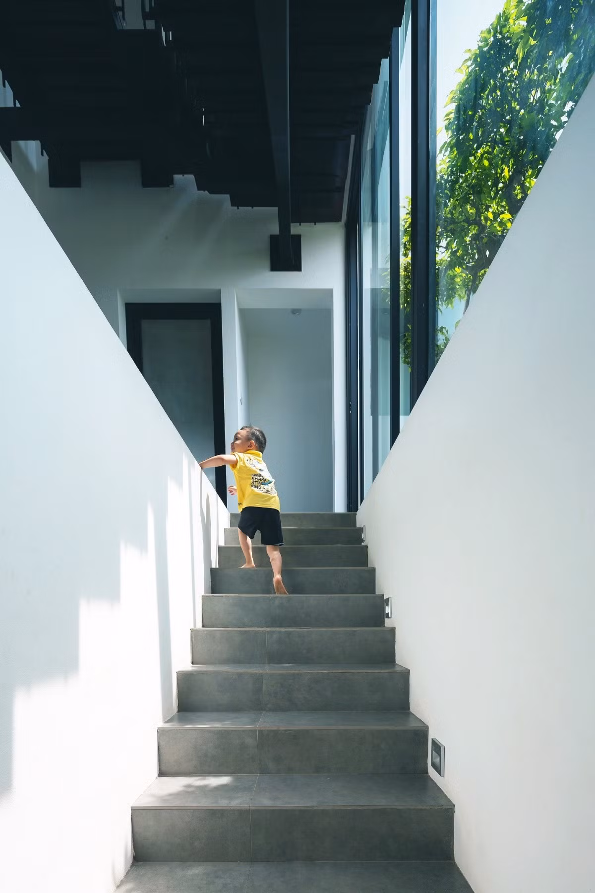 Liên kết tầng 2 và 3 là một cầu thang thép mặt gỗ hiện đại, năng động cùng với những hành lang chạy xuyên suốt tới từng phòng chức năng của tầng 3.