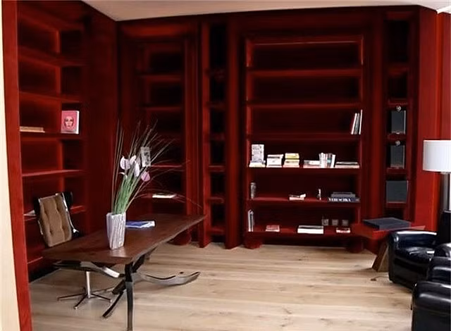 Trong phòng thư viện, tường được ốp vải nhung đỏ.