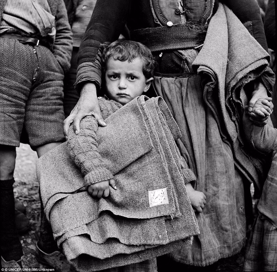 Một bé trai ở thị trấn Castoria cầm chặt tấm chăn được Quỹ UNICEF tài trợ năm 1950.