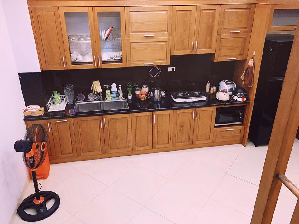 Phòng bếp gọn gàng với nội thất gỗ sang trọng.