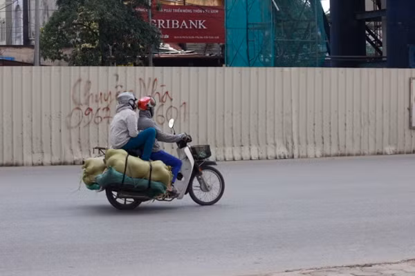 Xe máy được chế thêm hai bên gác nhằm thuận tiện vừa chở được người, vừa chở được hàng.