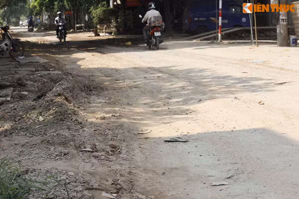 Thậm chí, lối ra vào nhà của người dân (bên trái) còn bị bùn đất ở đường "xâm chiếm".