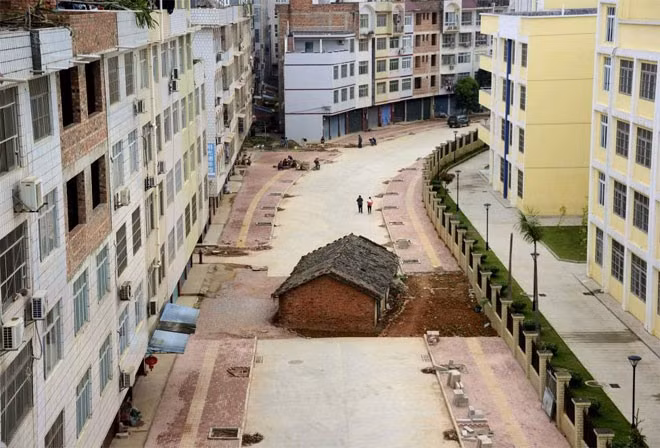 Một ngôi nhà "mọc thừa" còn gọi là "nhà đinh” (nail house - từ dùng để chỉ những ngôi nhà không chịu giải tỏa ở Trung Quốc) nằm giữa một con đường đang được xây dựng ở khu tự trị Chuang, Quảng Tây, Nam Ninh, Trung Quốc ngày 10/4/2015.