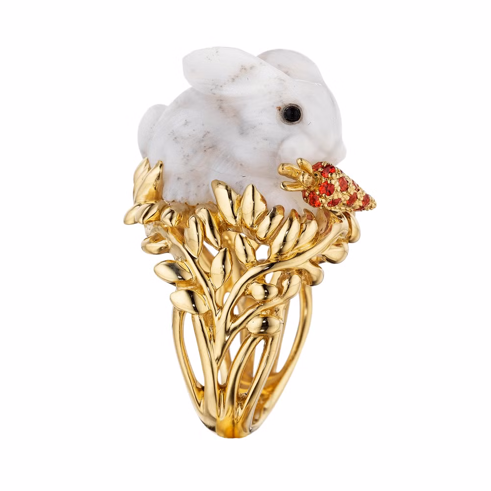 Chiếc nhẫn vàng 18 karat có gắn con thỏ trên mặt nhẫn và một củ cà rốt bằng đá sapphire màu cam.