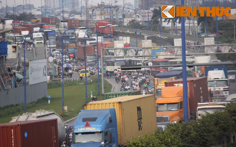 Hàng nghìn phương tiện xe tải, xe đầu kéo container, ô tô, xe khách... xếp hàng dài trên xa lộ Hà Nội nhích từng chút một qua cầu Rạch Chiếc...