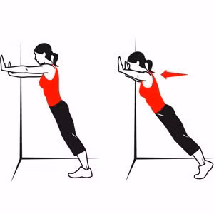 Động tác 3: "hít tường". Đứng cách tường 40cm, 2 tay chống thẳng vào tường. Thực hiện 10 lần động tác chống đẩy vào tường.