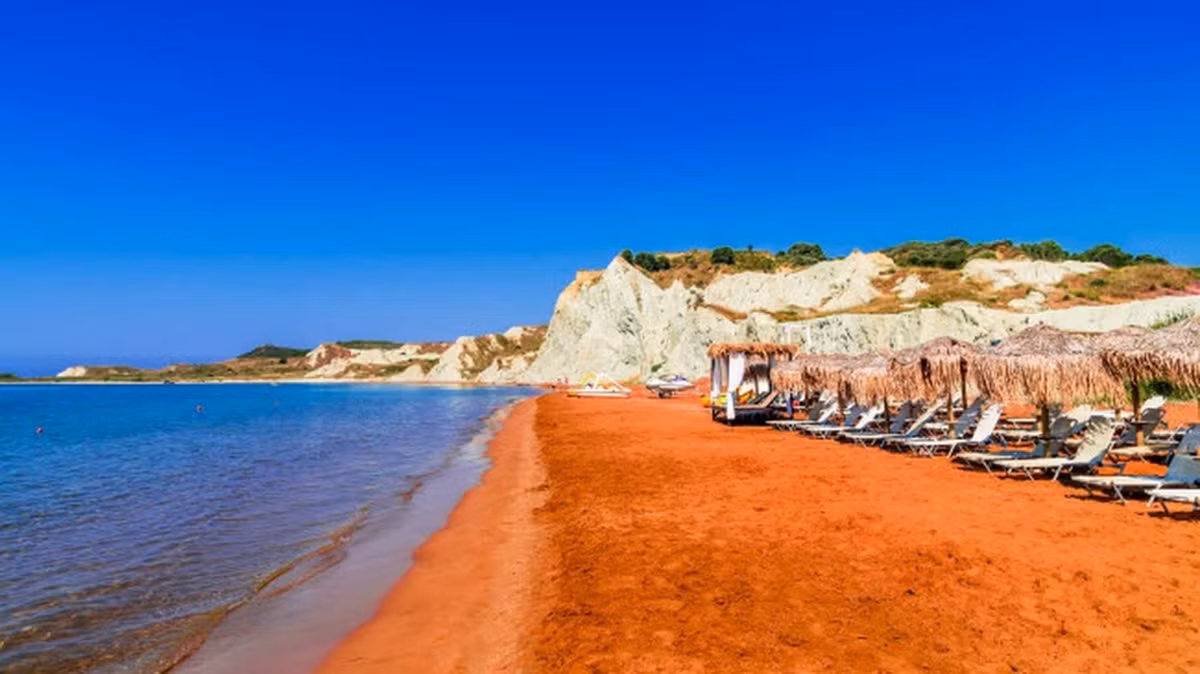 Bãi biển Xi, Hi Lạp: Bãi biển nằm trên hòn đảo Kefalonia nổi tiếng với các màu cam sặc sỡ. Nước biển ở đây ấm, nông và sóng nhẹ. Màu hồng của cát tương phản với vách đá màu trắng, tạo nên khung cảnh tuyệt mỹ. Ảnh: It.