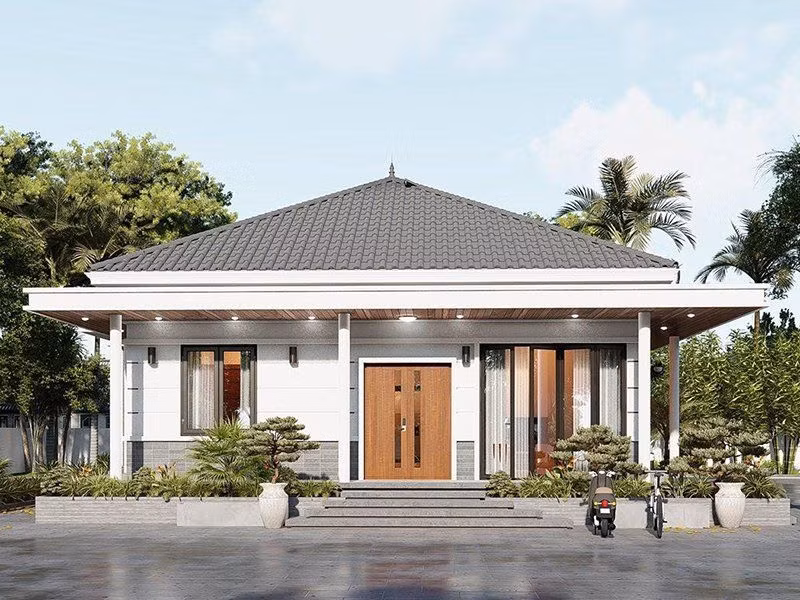 Mẫu nhà mái Nhật 1 tầng sử dụng hệ thống cửa kính cường lực trẻ trung, hiện đại. Tường ngoài ốp lớp gạch xám mộc giản dị. Ảnh: Xaynhadeponline