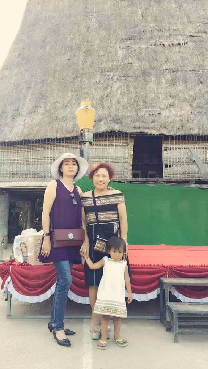 Siu Black chụp ảnh trước căn nhà Rông ở ngôi làng mà chị đang sinh sống.
