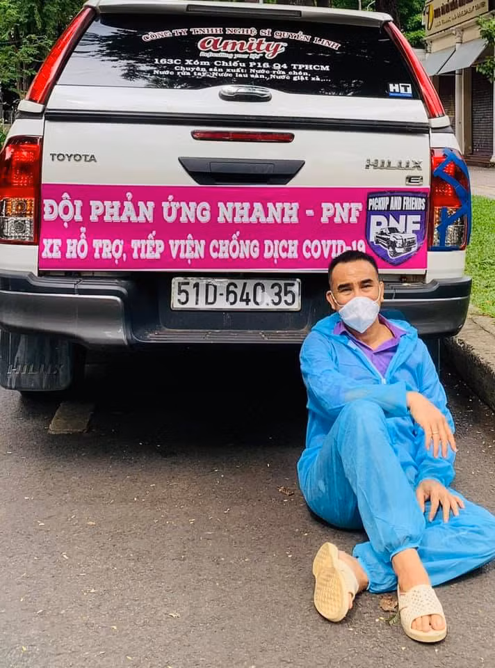  Quyền Linh: Trong bộ đồ bảo hộ, nam nghệ sĩ đi đến nhiều nơi để trao lương thực, thực phẩm cho lực lượng tuyến đầu, người dân ở các nơi bị phong tỏa, cách ly. Sau một buổi làm việc, MC Quyền Linh tranh thủ tựa đầu vào đuôi xe để nghỉ vì mệt.