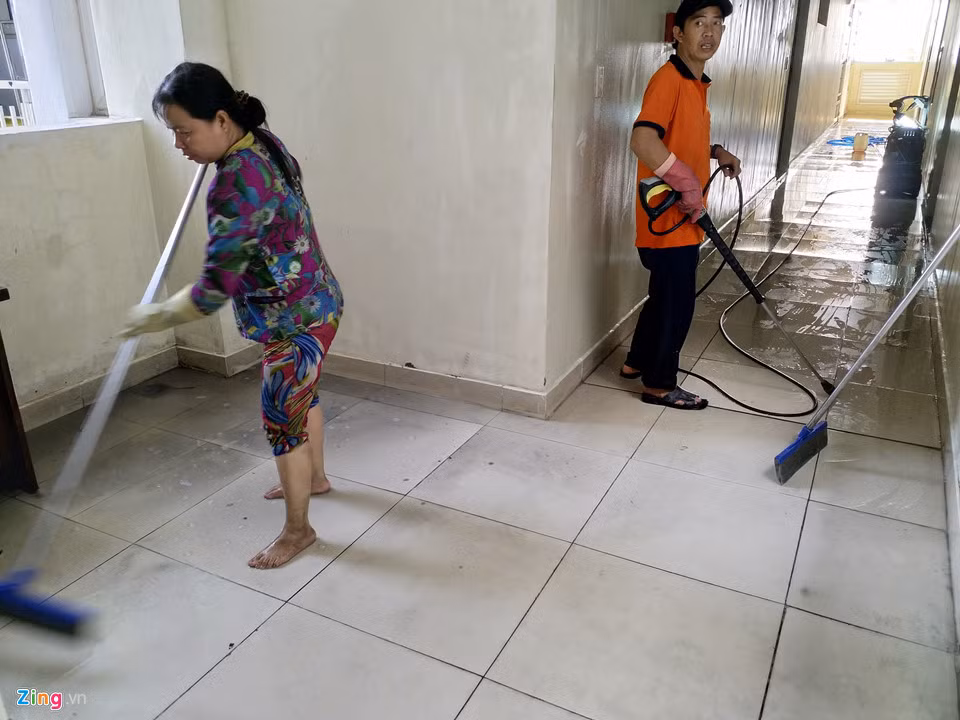 Những lao công được thuê để thu dọn block A và block B. "Nhóm tôi có 3 người, được trả 300.000 đồng/ngày, bao ăn trưa. Công việc chính là cọ rửa hành lang, sàn gạch, lau tường, trần nhà", chị Tâm chia sẻ với Zing.vn. Với tốc độ mỗi ngày dọn một tầng lầu như hiện nay, nhóm chị Tâm dự đoán hết tuần sau sẽ dọn sạch khu nhà. "Nhưng chỉ hành lang thôi, trong nhà thì chủ hộ tự dọn", anh Mạnh, một đồng nghiệp của chị Tâm, nói thêm.