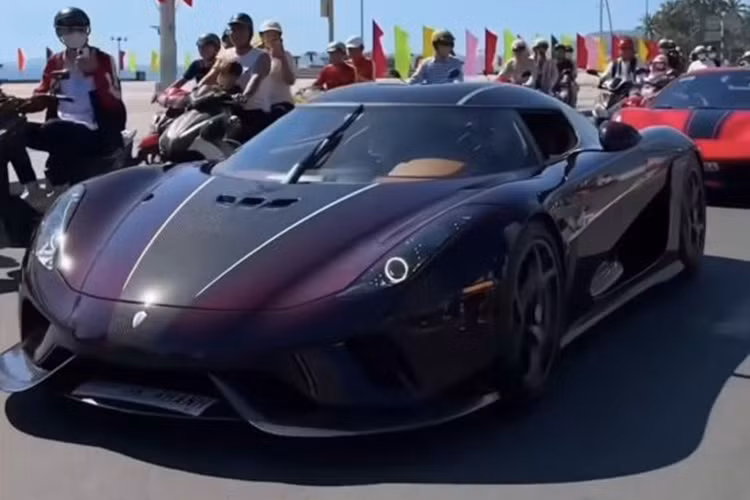 Được biết, chiếc Koenigsegg Regera của Hoàng Kim Khánh được vận chuyển bằng xe chuyên dụng từ TP.HCM đến Nha Trang. Khi chuẩn bị khui thùng để đưa xe ra, hàng trăm người dân đã đứng đó, mong ngóng được tận mắt chiêm ngưỡng siêu phẩm hai trăm tỷ này.