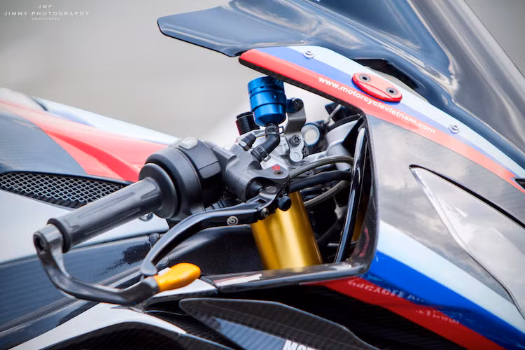Cùm phanh Brembo Rossi giúp hoàn thành hệ thống phanh trước của chiếc xe. Nằm ở phía trên tay lái của bản độ BMW S1000RR này đã được chủ xe trang bị không ít các phụ tùng "khủng" khác như bình dầu titan, bảo vệ tay phanh Lightech và cùm côn kèm tay CRG bằng sợi carbon. Giấu gọn dưới cổ, trong bộ quây gió của xe là cây trợ lực Ohlins.