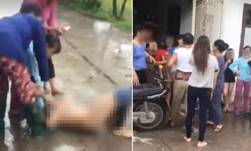 Hình ảnh người phụ nữ cho là "cặp kè" với chồng người khác đang bị người vợ "đánh ghen", lột đồ giữa đường. Ảnh cắt từ clip.