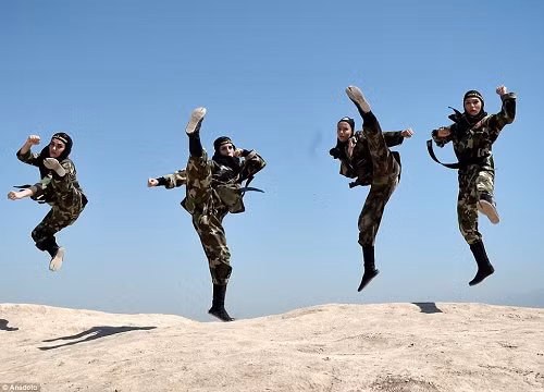 Huấn luyện viên Ninjutsu Fatima Muamer nói rằng “môn thể thao” tại trung tâm ngày càng hấp dẫn phụ nữ vì nó giúp duy trì sự cân bằng giữa cơ thể và tâm trí. Cô nói: “Bài học quan trọng nhất trong ninjutsu là sự tôn trọng và khiêm tốn”. Ảnh: Bốn trong số những nữ chiến binh mặc đồng phục ngụy trang thực hiện những cú đá cao - một trong những kỹ năng học được trong quá trình đào tạo.