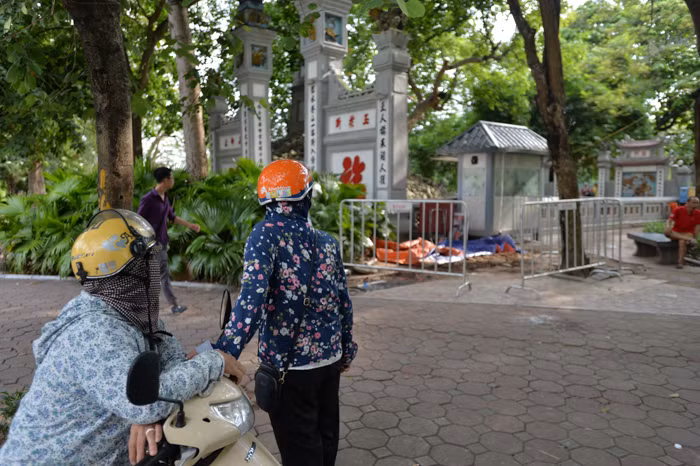 Nhiều người dân hiếu kì đứng lại xem hiện trường vừa đào được 7 tiểu quách cổ xưa.